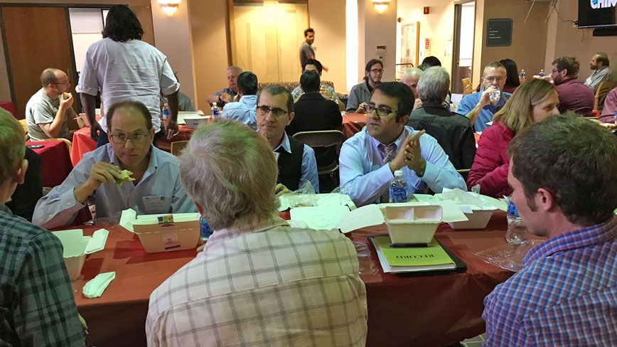 Professor Arash Mafi enjoys discussions at lunch