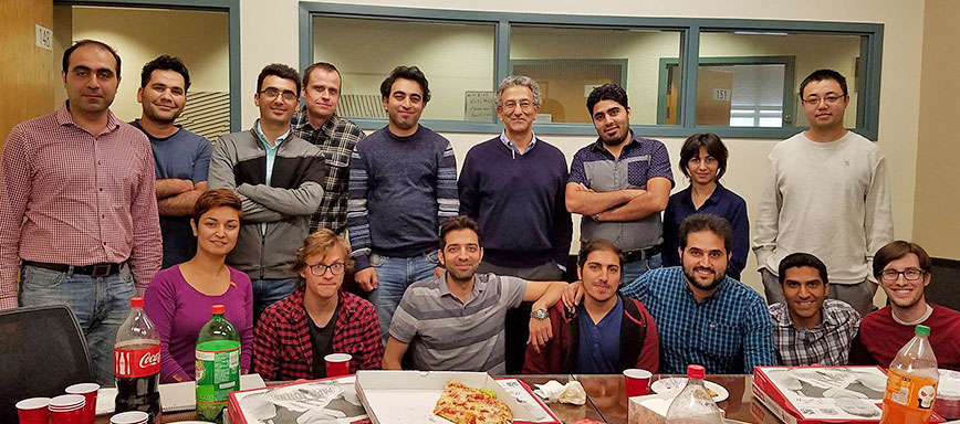 Nader Engheta enjoys a pizza party with the students
