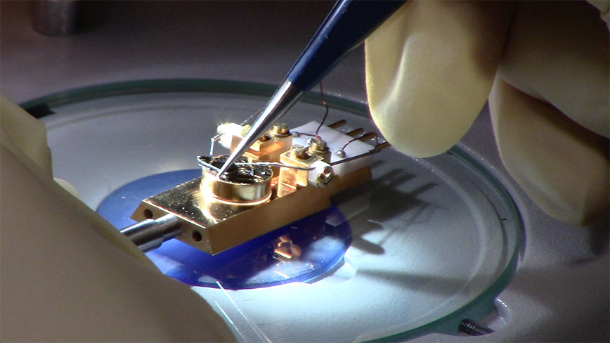 Probes are placed in contact with a sample under a microscope